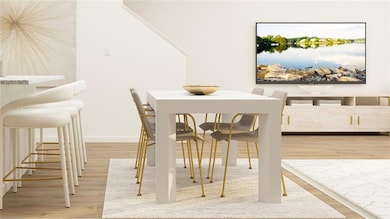 Dining space featuring a water view and light hardwood / wood-style flooring