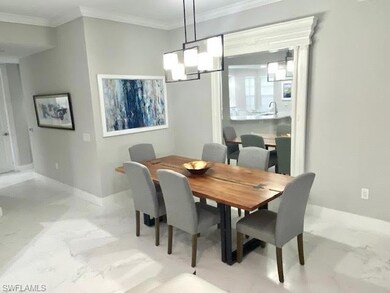Dining room featuring crown molding and a chandeli