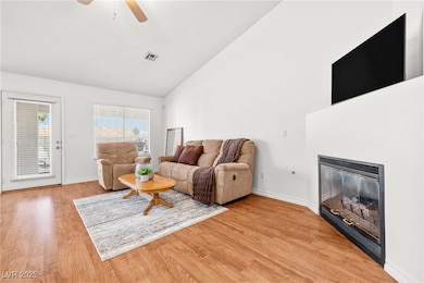 Living room with high vaulted ceiling, a glass cov