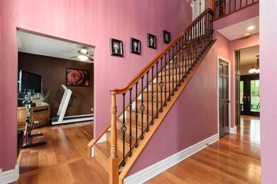 Dramatic 2 story entry with gleaming hardwood floors.