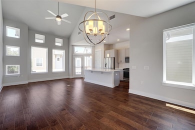 Unfurnished living room featuring dark wood-type 