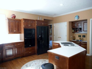 The kitchen has double oven and a nice island , al
