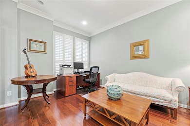 The home office features rich wood flooring and la