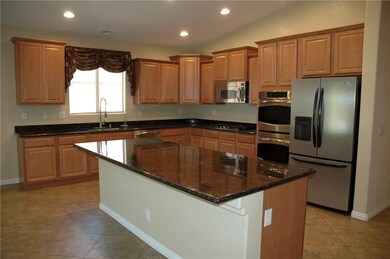 Large gourmet kitchen with upgraded cabinets, gran