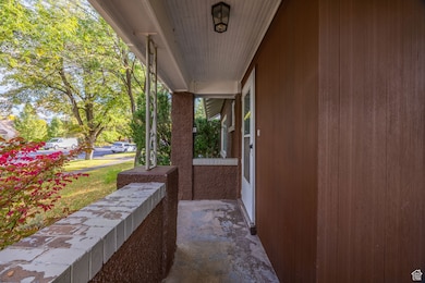 Covered porch featuring a yard