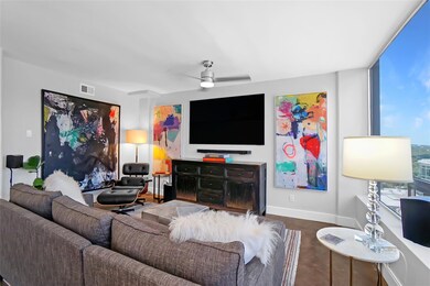 Living room featuring baseboards and a ceiling fan
