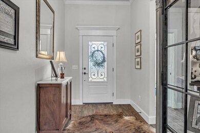 Entrance foyer featuring ornamental molding and da