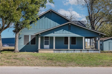 Bungalow-style house with a porch and a front yard