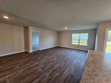 Unfurnished living room with dark wood-type floori