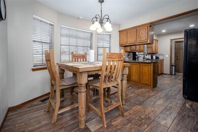 Dining room featuring sink, dark wood-type floorin