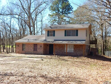 Traditional-style house with driveway, brick sidin