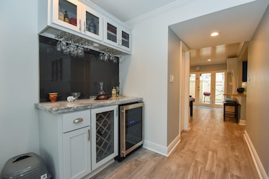 Dry bar with wine fridge, wine rack and cabinets