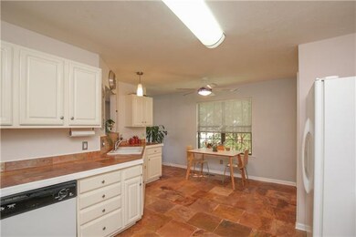 Another view of the kitchen which shows the eating area
