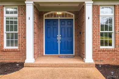 View of exterior entry with brick siding