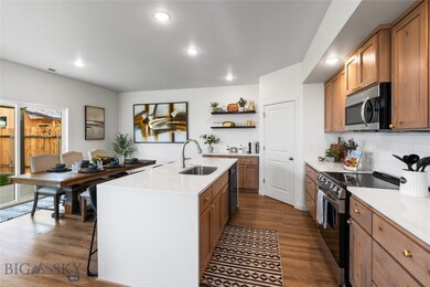 Kitchen with dark wood-type flooring, a center isl
