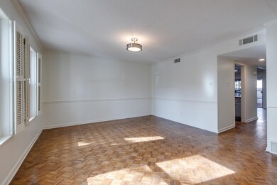 Unfurnished room featuring parquet flooring, ornam