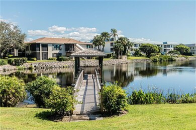 Dock area with a gazebo, a water view, and a lawn