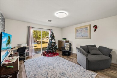 Living room with light hardwood / wood-style floor