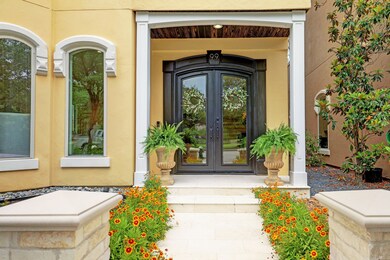 This stunning showcases a beautifully designed home with a limestone floor and a charming display of roses and trailing white lantana. The automatic light sensor adds a touch of convenience and modernity to the overall aesthetic.

