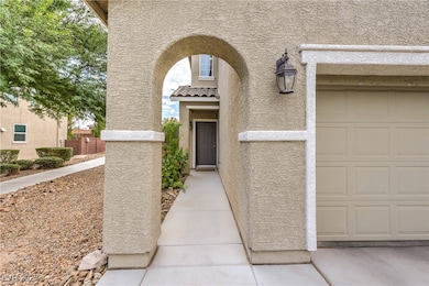 View of exterior entry with stucco siding and a garage