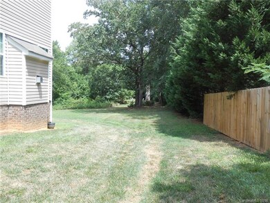 View of the back yard from the right side yard.