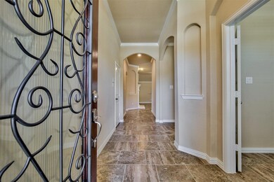 Hallway with crown molding and tile flooring