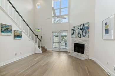 Wonderful two story living room with a wall of win