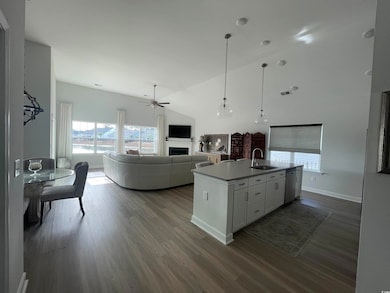 Kitchen featuring LVP throughout, White Cabinetry,