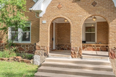 View of exterior entry featuring brick siding, sto