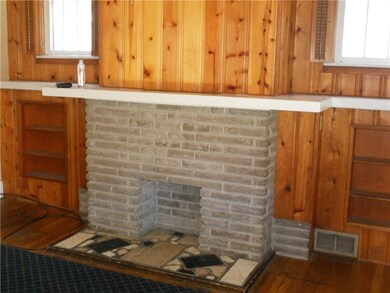 Decorative brick fireplace in living room with man