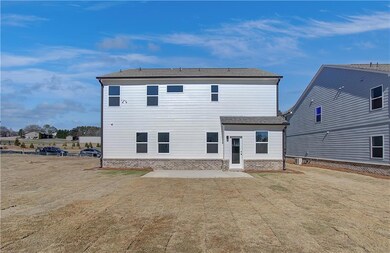 Back of property featuring an oversized backyard a