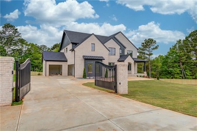 French country style house featuring a gate, concr