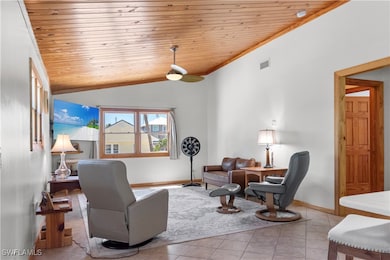 Tiled living area with tongue and groove vaulted w
