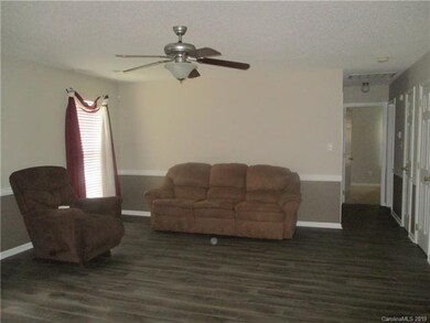 another view of Great room and hallway to 2 other 