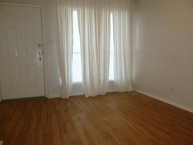 Entryway with light wood-style flooring and baseb