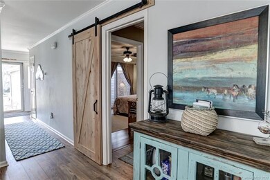 Entry hall looking back toward front door. Barn door for cove to guest bedroom and bath