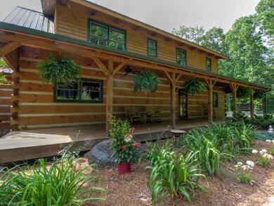 Enjoy watching wildlife from this amazing 50x10 rocking chair front porch complete with ceiling fans and beautiful landscaping!