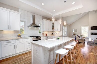 Kitchen with quartz counters, apron sink and large
