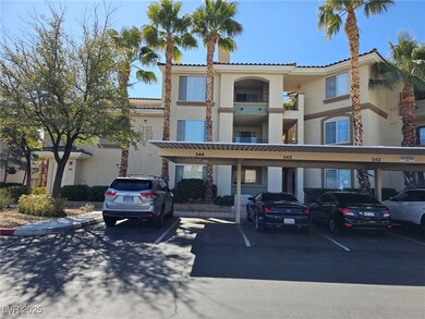 View of building exterior featuring covered parkin