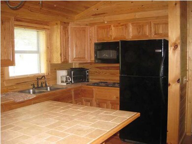 Kitchen with refrigerator, stove top, toaster oven