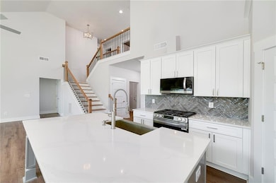 Kitchen with tasteful backsplash, a high ceiling, 