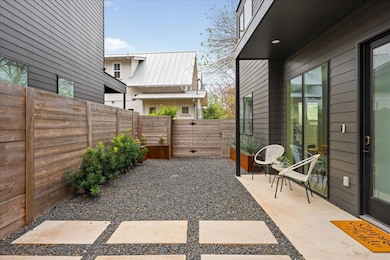 Enjoy private outdoor living with a covered patio and easy maintenance xeriscape landscaping. 