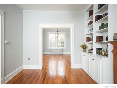 View of living room, looking into dining room.
