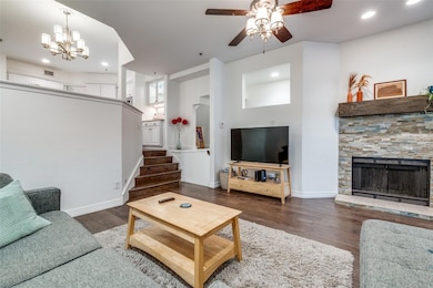 Living room with ceiling fan with notable chandeli
