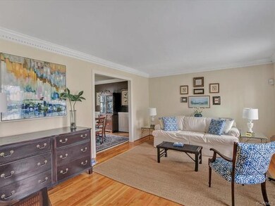 Living room off the foyer with hardwood floors, de