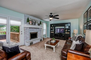 Great furniture arrangements possible thanks t the half wall and centrally placed fireplace.
