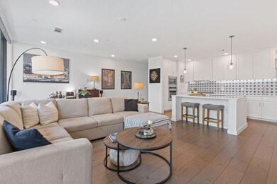Living area with recessed lighting and dark wood 