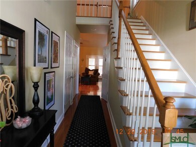 Two story entry way features gleaming hardwood flo