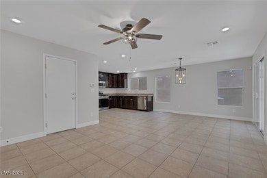 Unfurnished living room with a ceiling fan, a sink