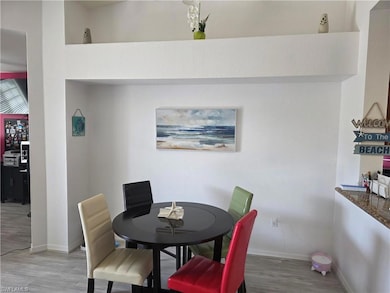 Dining space with light wood-type flooring and baseboards